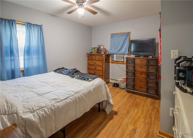 bedroom with hardwood / wood-style flooring, a baseboard radiator, ceiling fan, and cooling unit