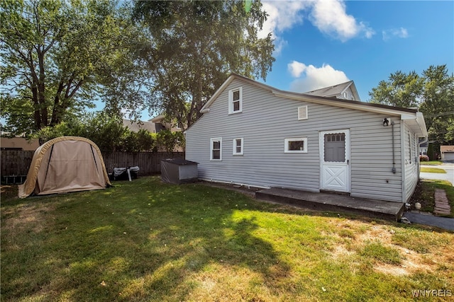 back of house featuring a yard