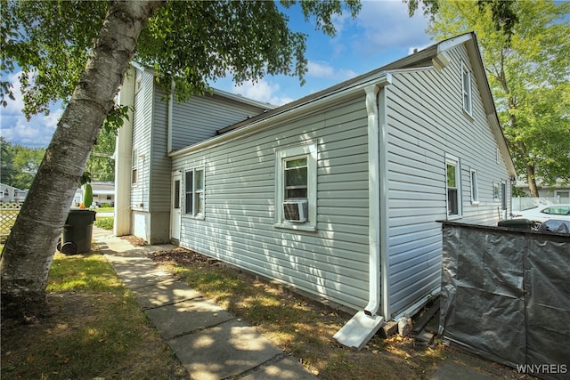 view of side of property with cooling unit