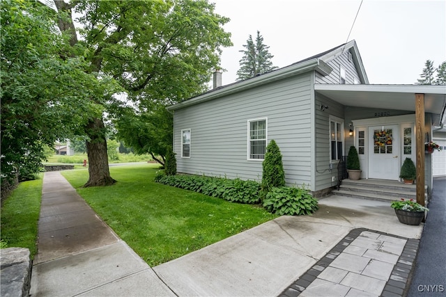 view of property exterior with a lawn