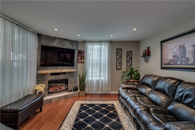 living room featuring a premium fireplace and hardwood / wood-style floors