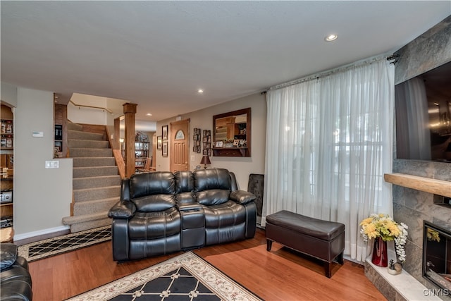 living room featuring hardwood / wood-style flooring and a tiled fireplace