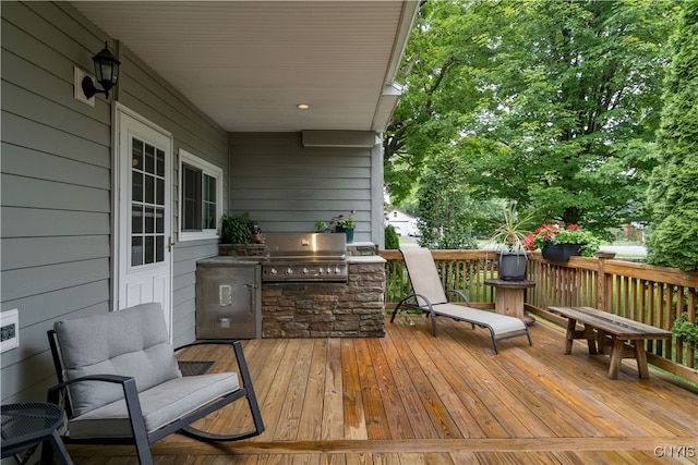 deck featuring grilling area and an outdoor kitchen