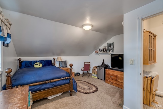 bedroom featuring lofted ceiling and carpet floors