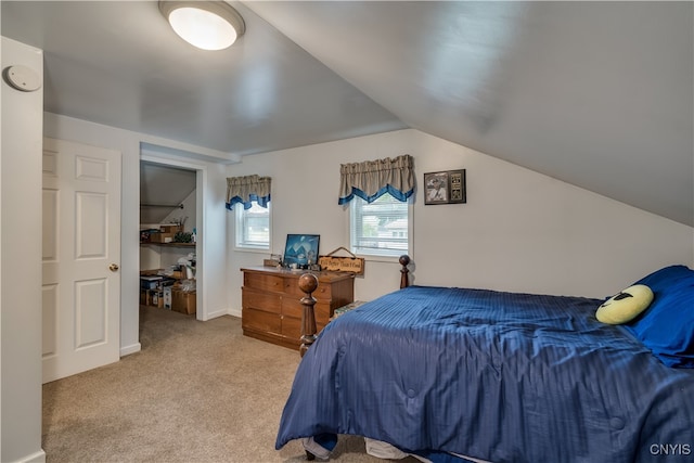 carpeted bedroom featuring vaulted ceiling