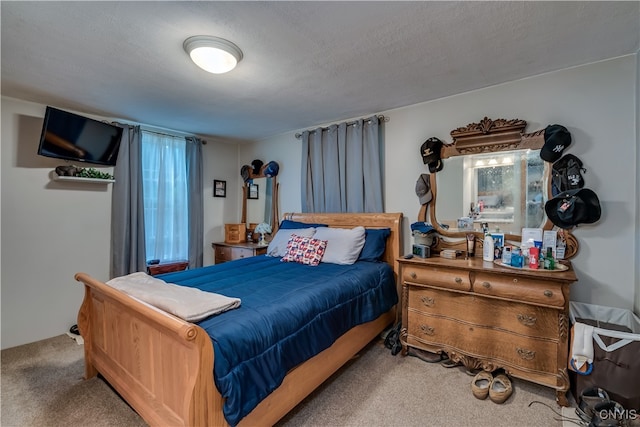 bedroom with carpet and a textured ceiling