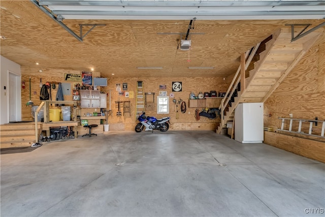 garage with a workshop area and a garage door opener