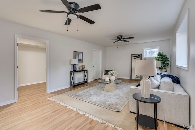 living room featuring ceiling fan and light hardwood / wood-style flooring