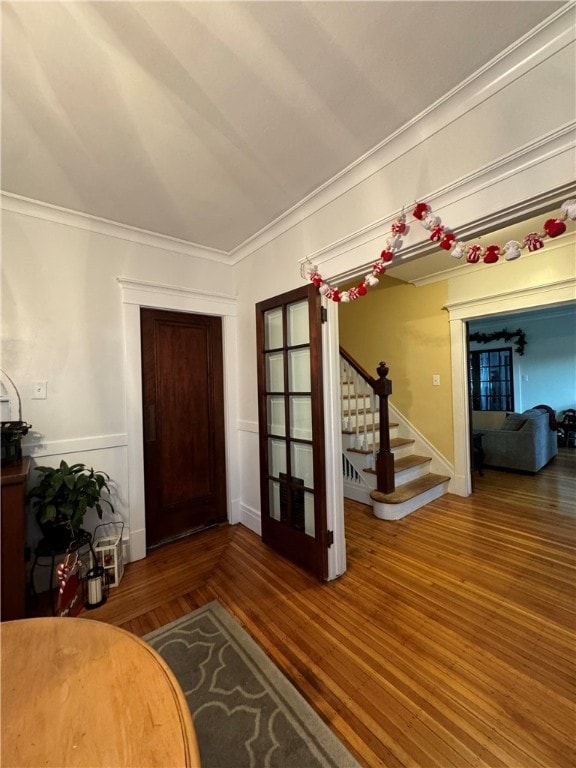 foyer with crown molding and dark hardwood / wood-style floors