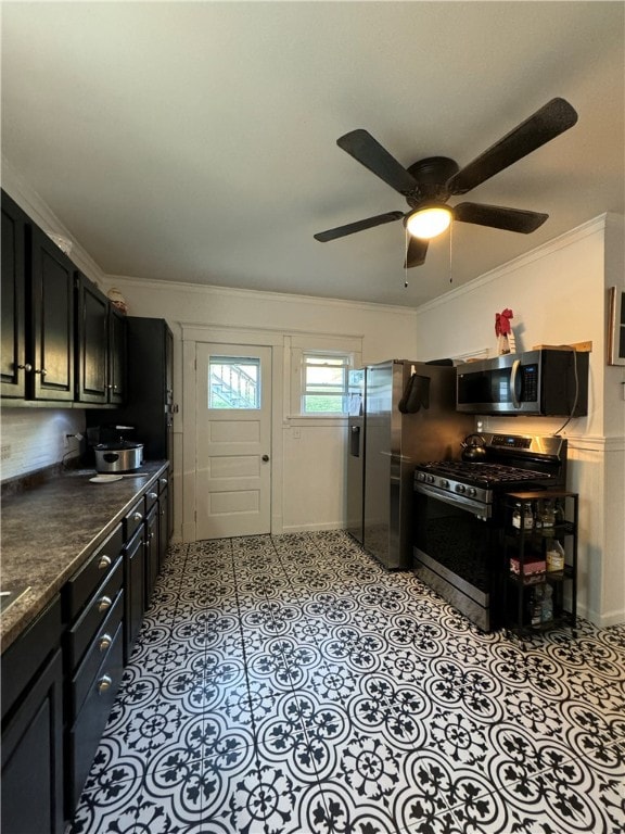 kitchen with ceiling fan, ornamental molding, and stainless steel appliances