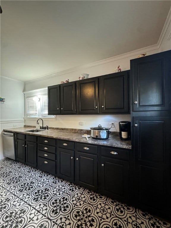 kitchen featuring stainless steel dishwasher, ornamental molding, and sink