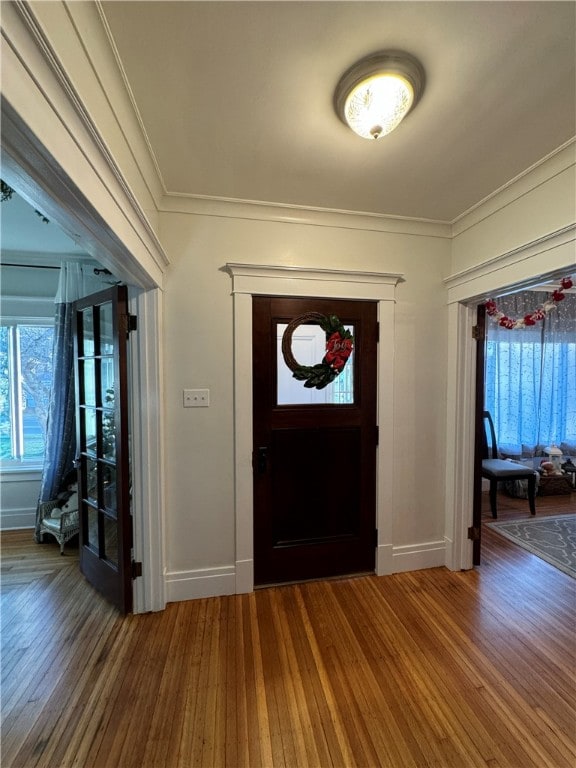 entryway featuring hardwood / wood-style flooring and crown molding