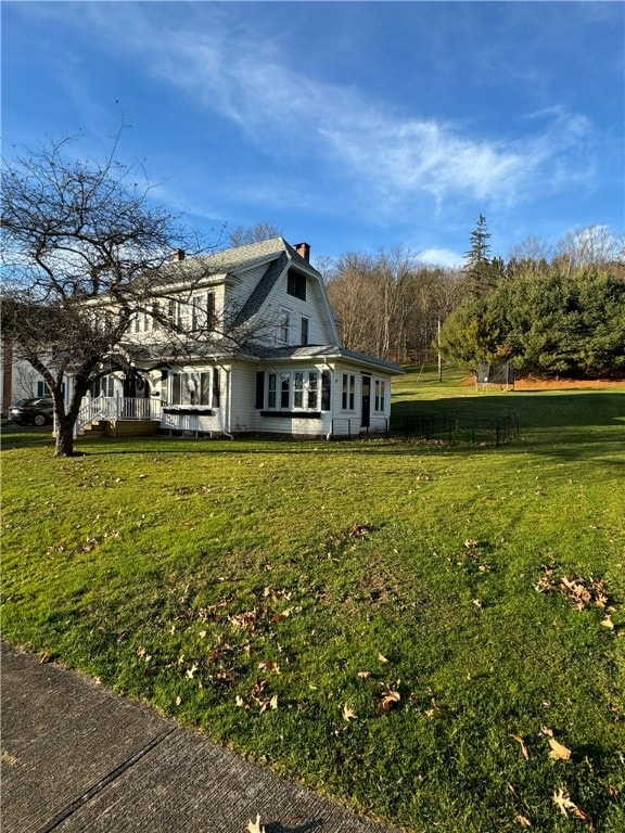 view of side of home featuring a yard