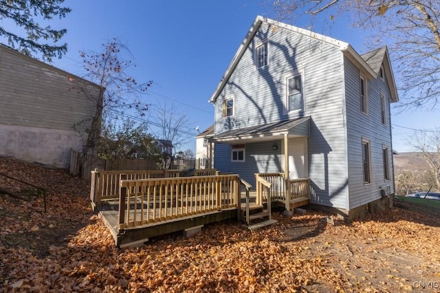 rear view of property with a wooden deck