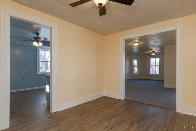 unfurnished room featuring dark hardwood / wood-style flooring and a healthy amount of sunlight