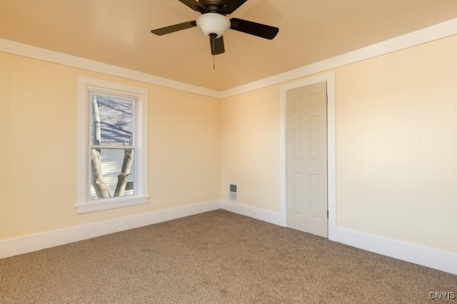 spare room with carpet flooring, ceiling fan, and crown molding