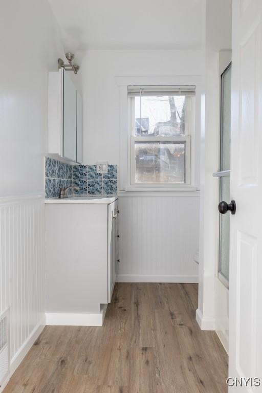 bathroom with vanity, combined bath / shower with glass door, and hardwood / wood-style flooring