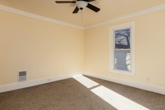 carpeted spare room featuring ceiling fan and ornamental molding