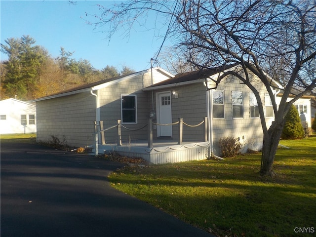 rear view of property with a lawn