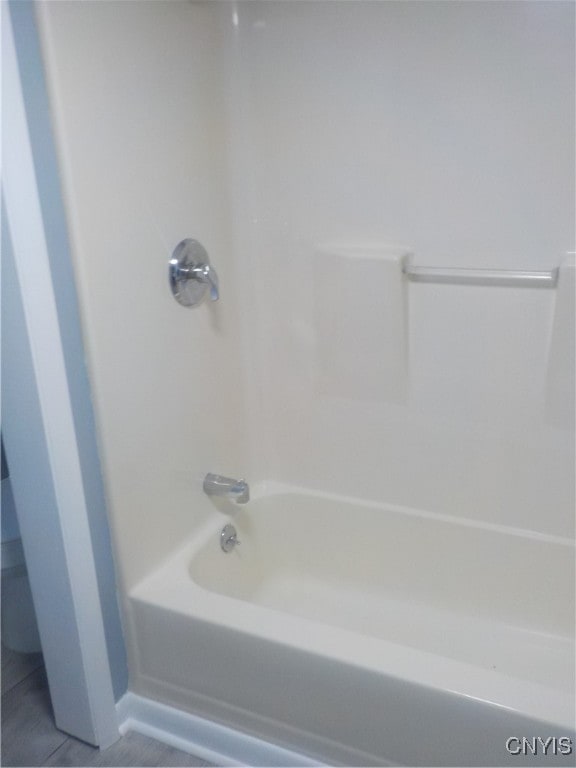 bathroom featuring tile patterned flooring and washtub / shower combination