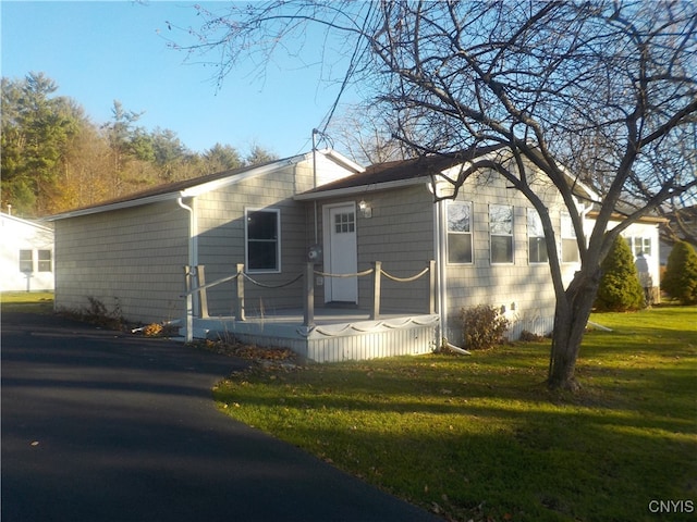 rear view of property with a lawn