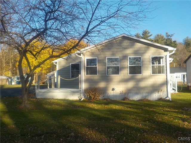 view of side of property with a lawn