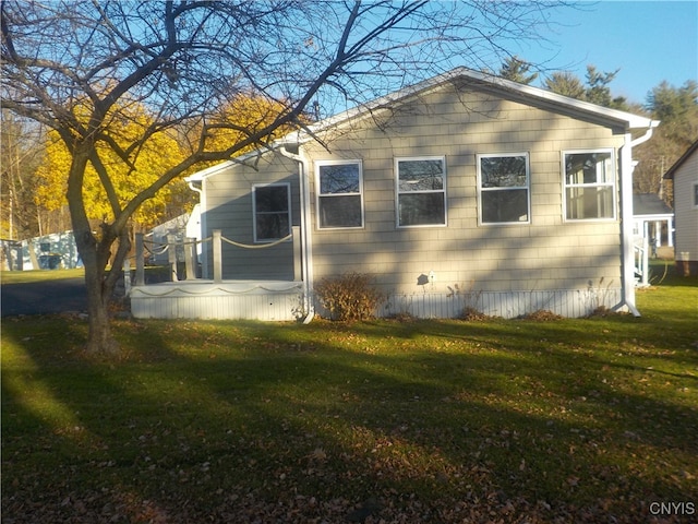 view of side of home featuring a yard