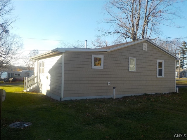 view of home's exterior with a lawn