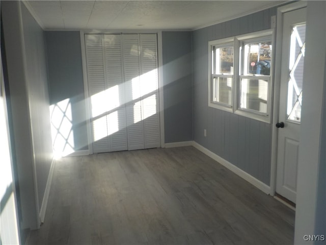 spare room with dark hardwood / wood-style floors and ornamental molding