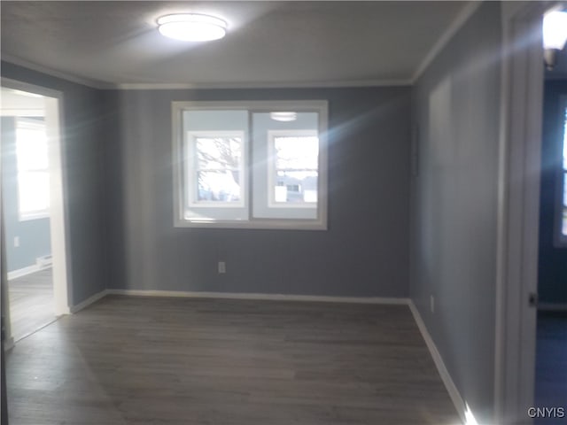 unfurnished room with dark hardwood / wood-style flooring and crown molding