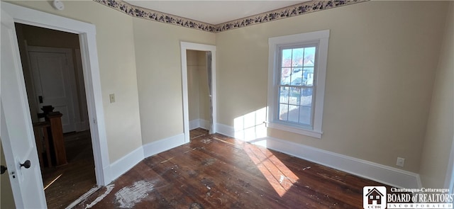 unfurnished room with dark hardwood / wood-style floors