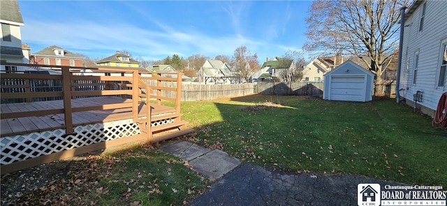 view of yard with a storage shed and a wooden deck