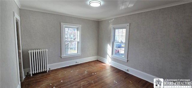 unfurnished room with radiator, a wealth of natural light, crown molding, and dark hardwood / wood-style floors