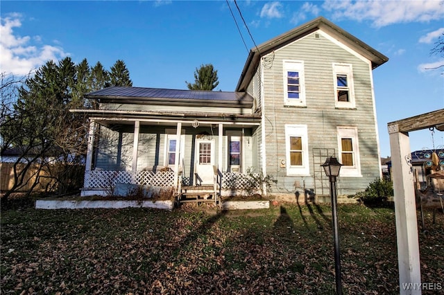 back of property with covered porch