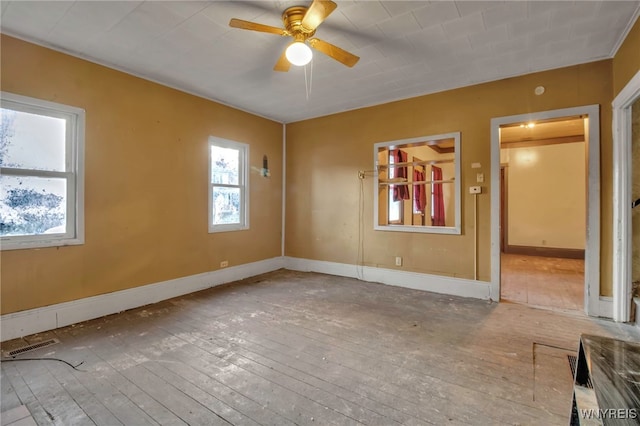 spare room featuring hardwood / wood-style flooring and ceiling fan