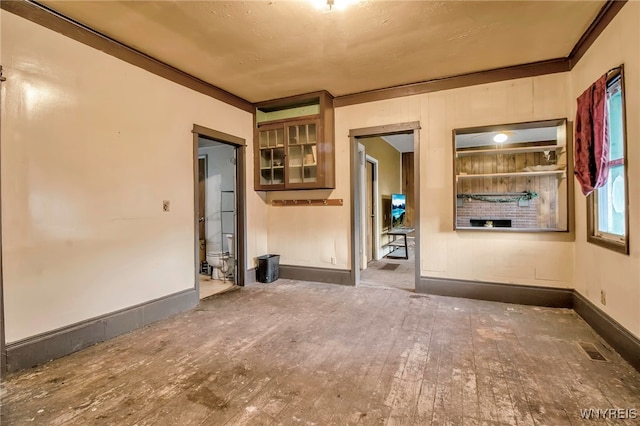 spare room with wood-type flooring and crown molding