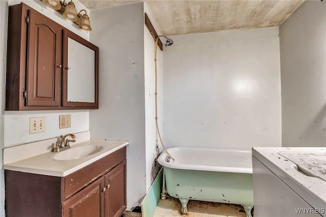 bathroom with a tub to relax in and vanity