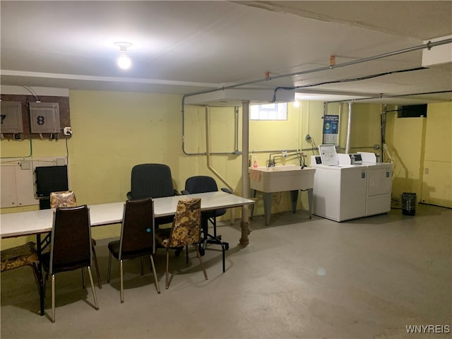 basement featuring washing machine and dryer and sink