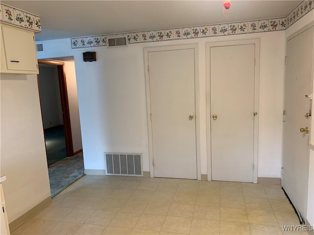 unfurnished bedroom with multiple closets