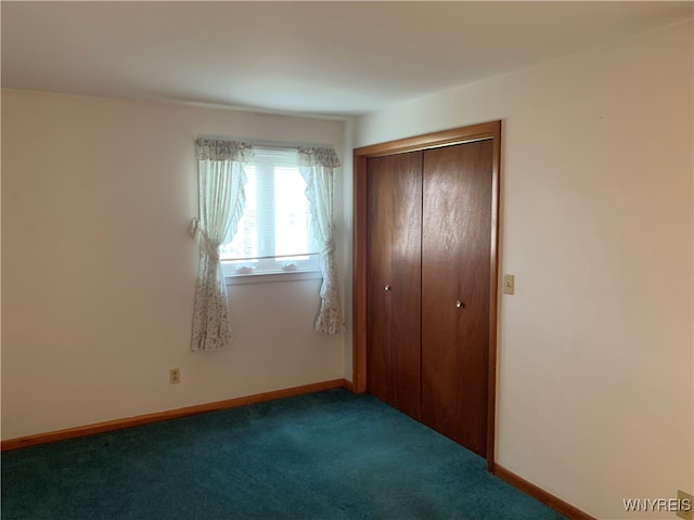 unfurnished bedroom featuring carpet floors and a closet