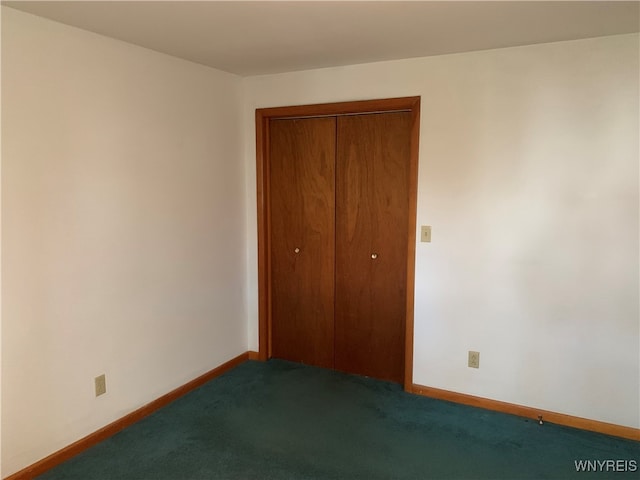 unfurnished bedroom featuring carpet flooring and a closet