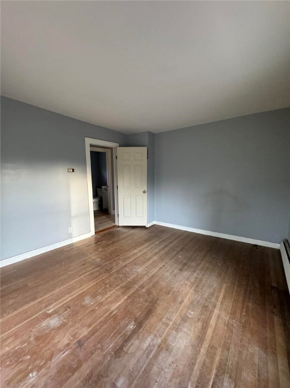 spare room featuring wood-type flooring