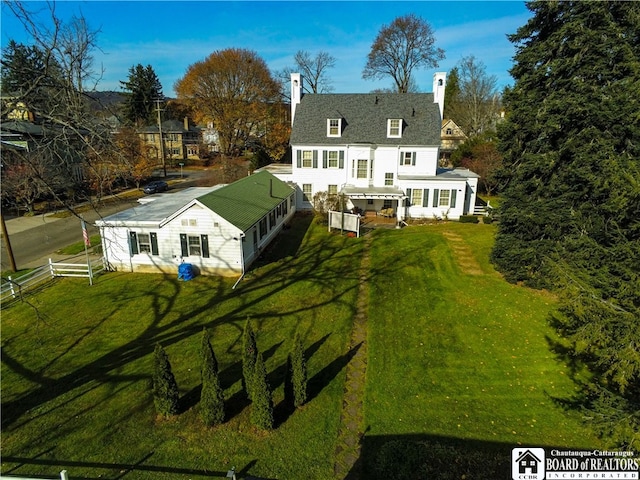 back of property with a yard and a sunroom