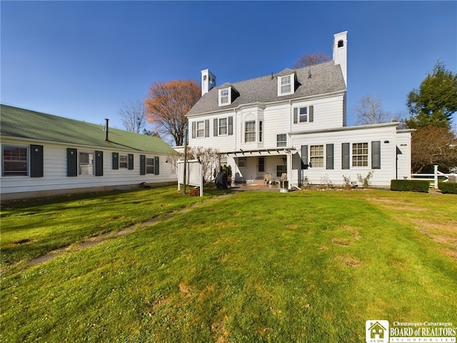 back of house with a pergola, a patio, and a lawn