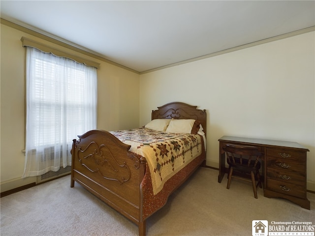 carpeted bedroom with ornamental molding