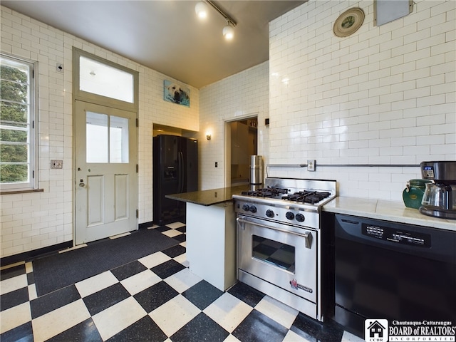 kitchen with track lighting and black appliances