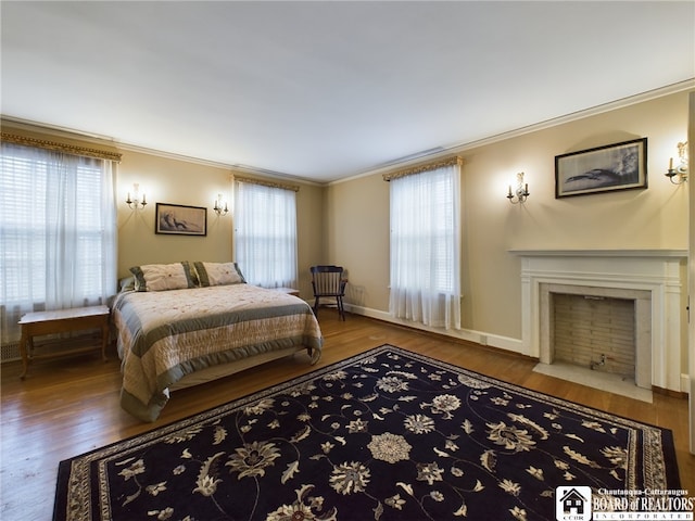 bedroom with multiple windows, wood-type flooring, and ornamental molding