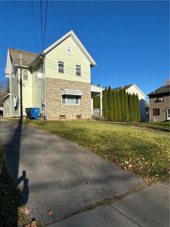 view of property exterior featuring a yard