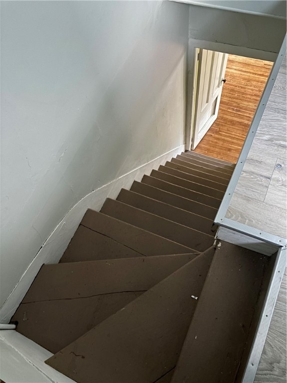 stairway featuring wood-type flooring