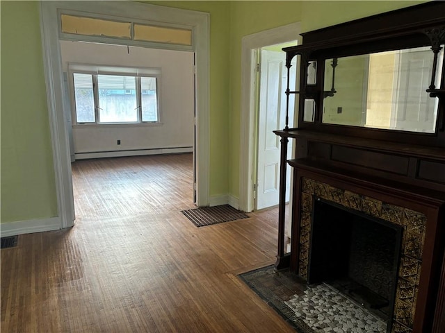 hall featuring hardwood / wood-style flooring and a baseboard heating unit